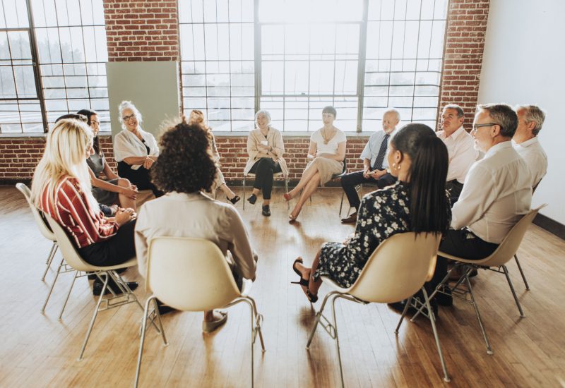 People sitting and talking with a group People sitting and talking with a group